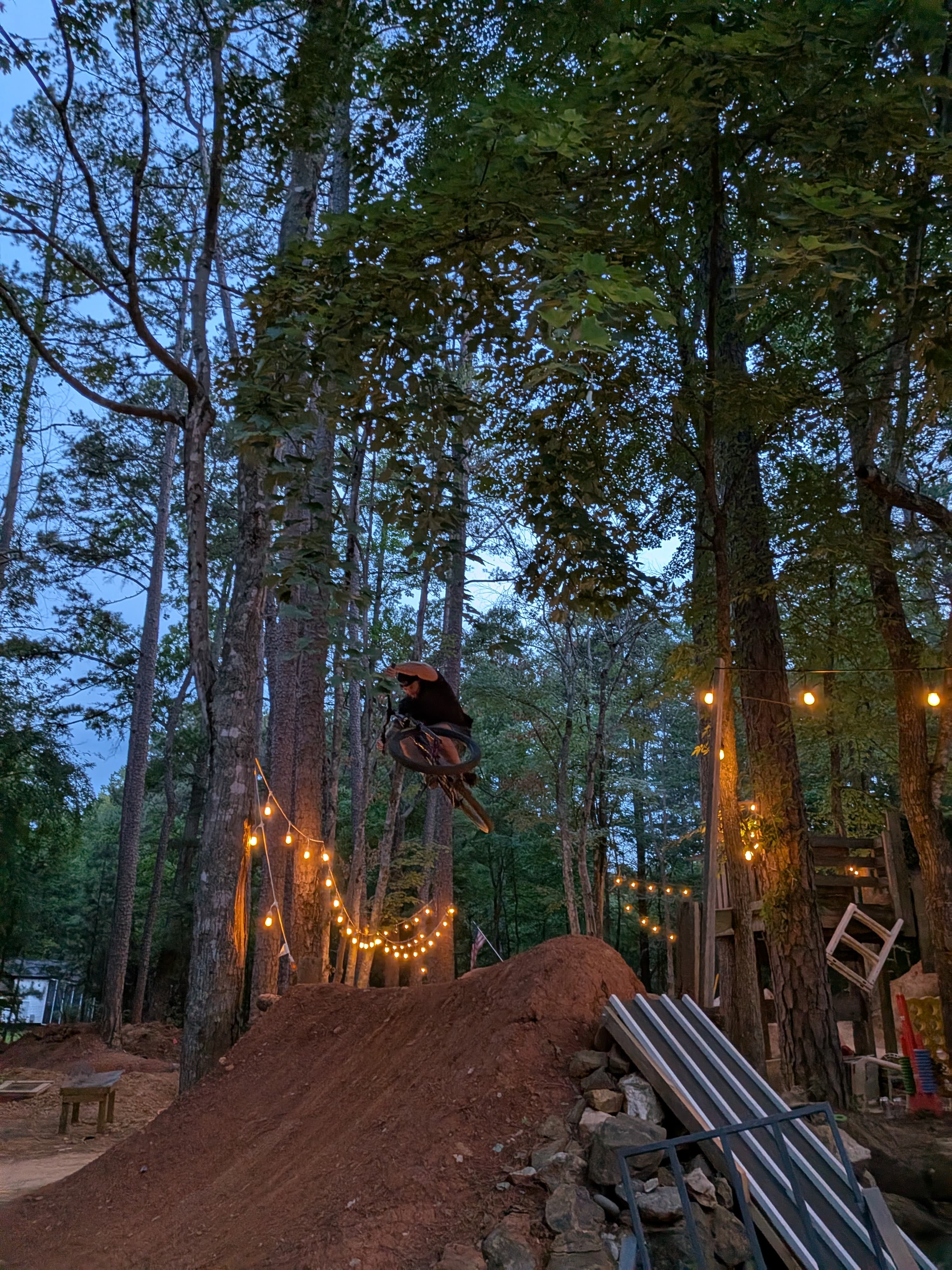 Jump session at dusk with lights in the trees