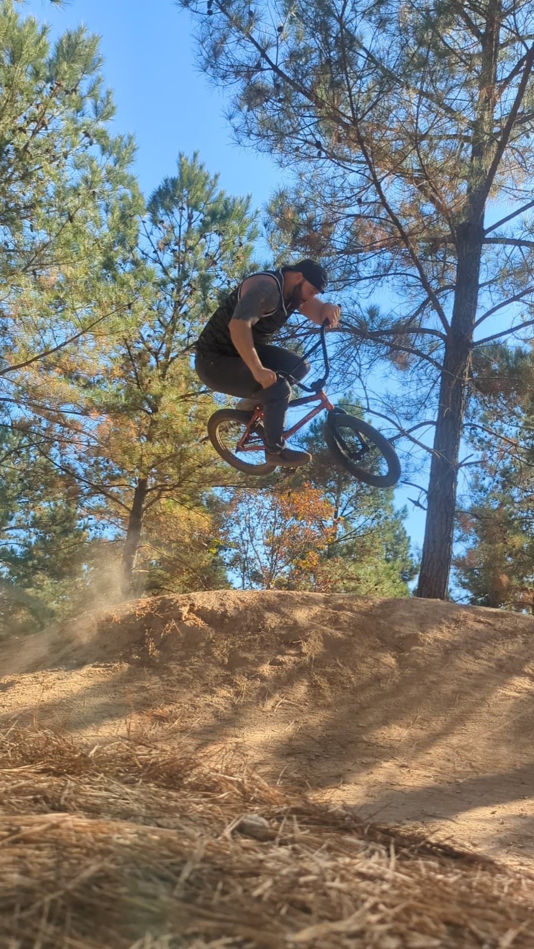Instructor catching big air on a dirt jump