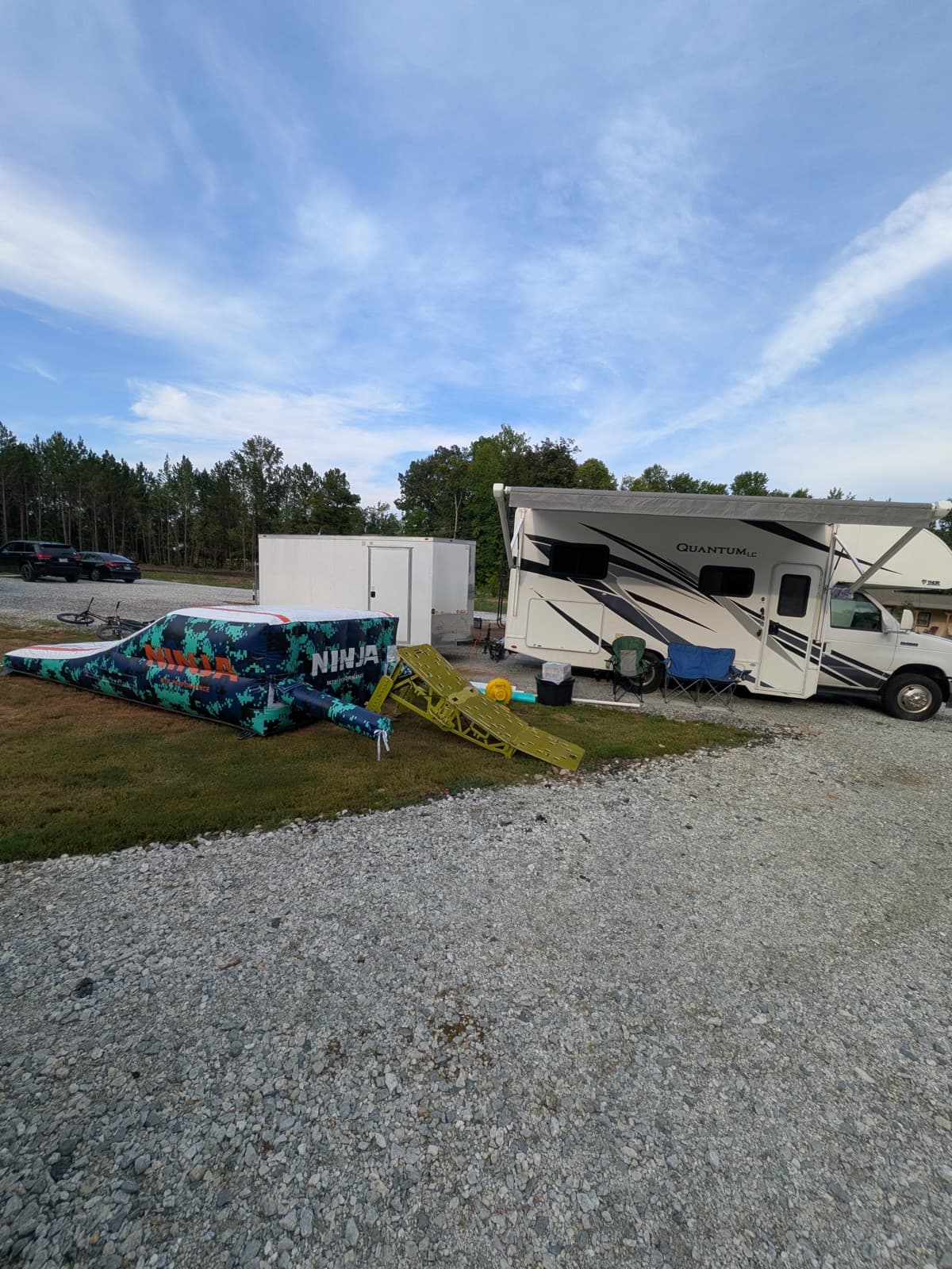 Mobile BMX setup: portable ramp, Ninja air bag, and coach RV