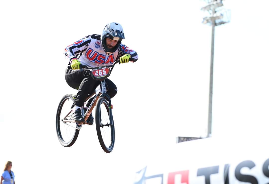 Team USA BMX rider jumping at a professional competition